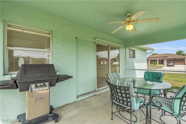 view of patio / terrace with ceiling fan, grilling area, and a garage