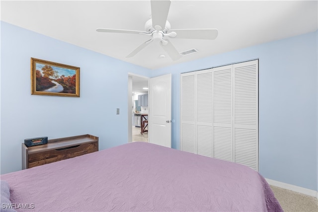 carpeted bedroom featuring ceiling fan and a closet