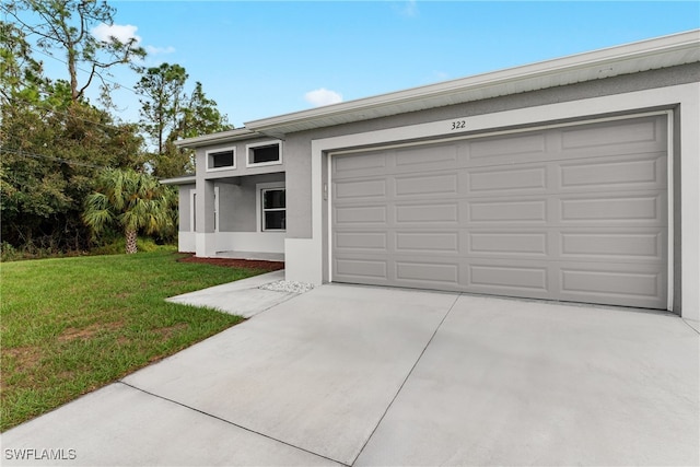 view of front of property with a front lawn and a garage