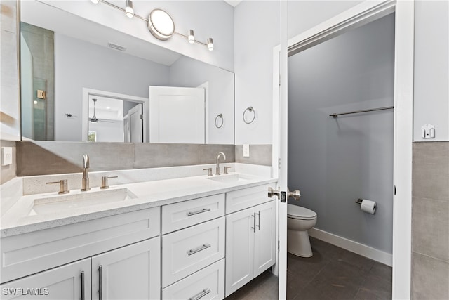 bathroom featuring vanity, toilet, and tile patterned flooring