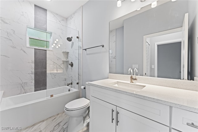 full bathroom featuring vanity, tiled shower / bath combo, and toilet