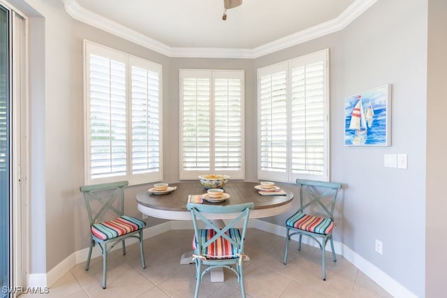 tiled dining room featuring ornamental molding