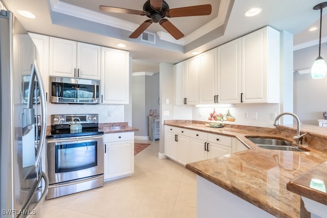 kitchen featuring stainless steel appliances, white cabinetry, and sink