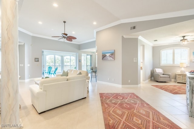 tiled living room with french doors, lofted ceiling, ceiling fan, and crown molding