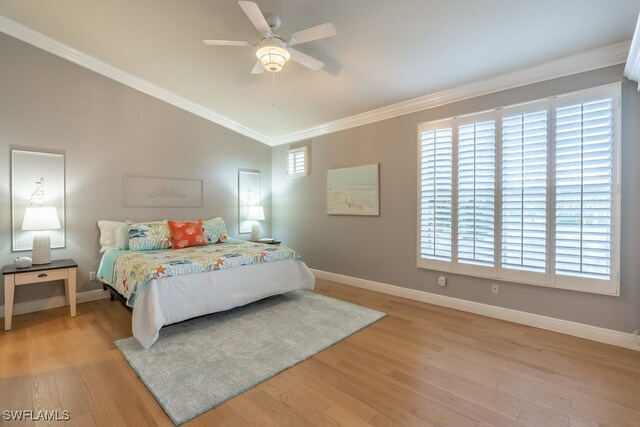 bedroom with ceiling fan, multiple windows, and light hardwood / wood-style flooring