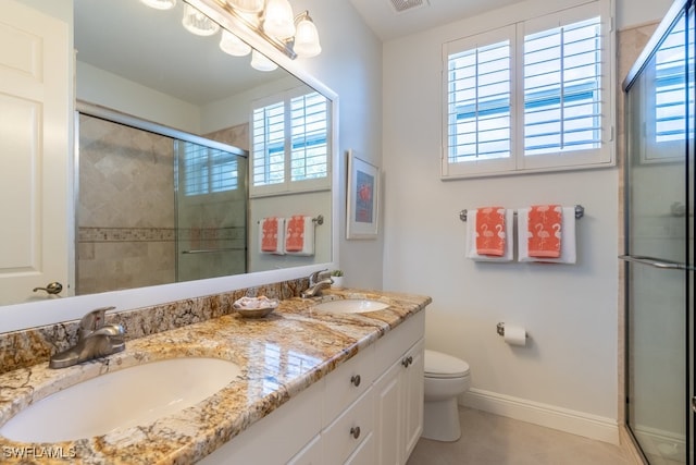 bathroom featuring toilet, a wealth of natural light, and walk in shower