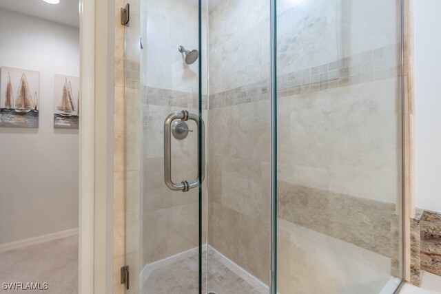 bathroom featuring a shower with shower door