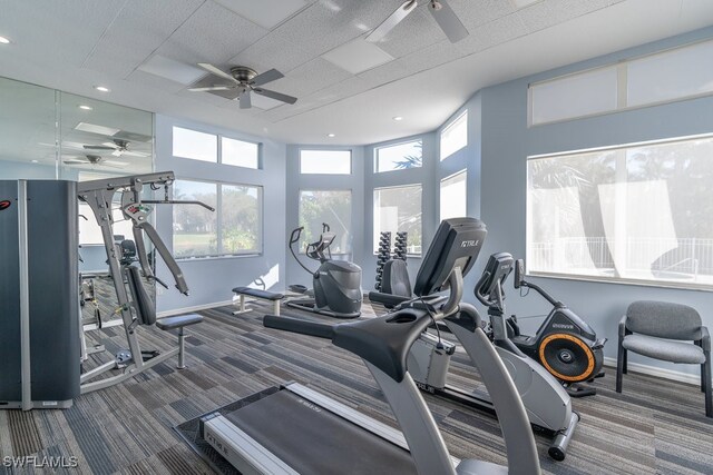 workout area featuring ceiling fan and carpet floors