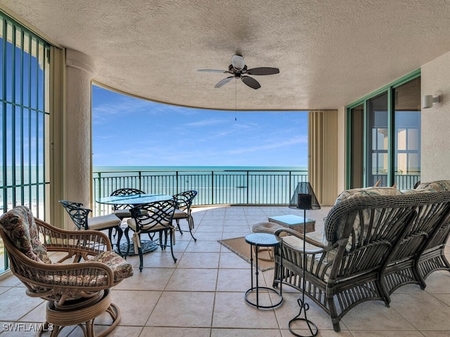 view of patio / terrace with a water view and ceiling fan