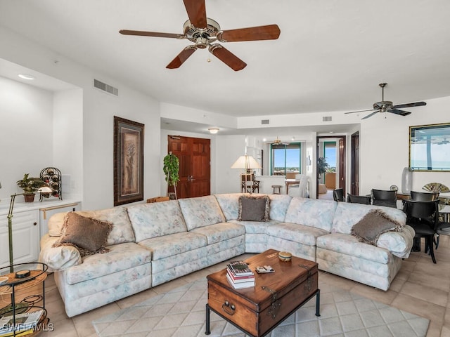 tiled living room with ceiling fan