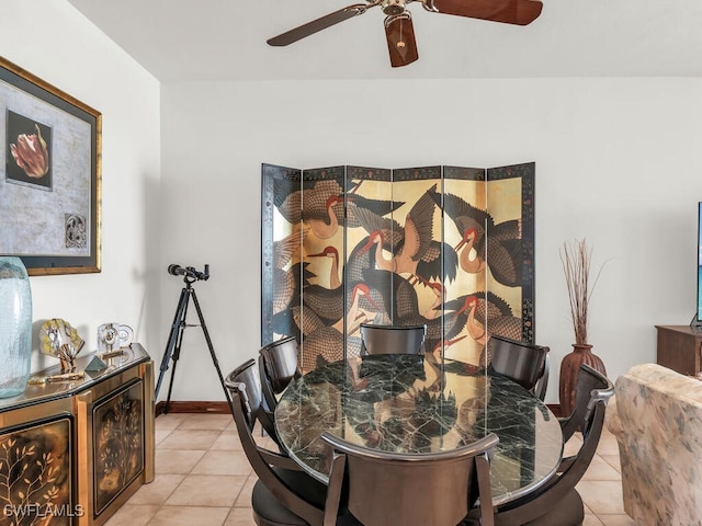 tiled dining area featuring ceiling fan