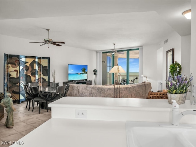 interior space with ceiling fan, tile patterned floors, and sink