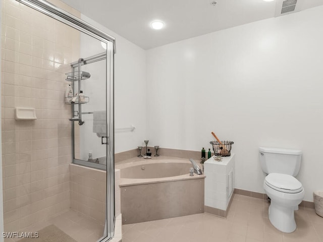 bathroom featuring toilet, shower with separate bathtub, and tile patterned flooring