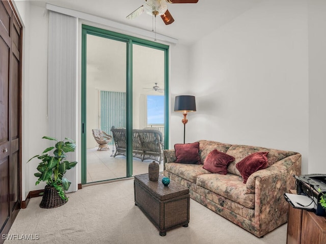 carpeted living room with ceiling fan