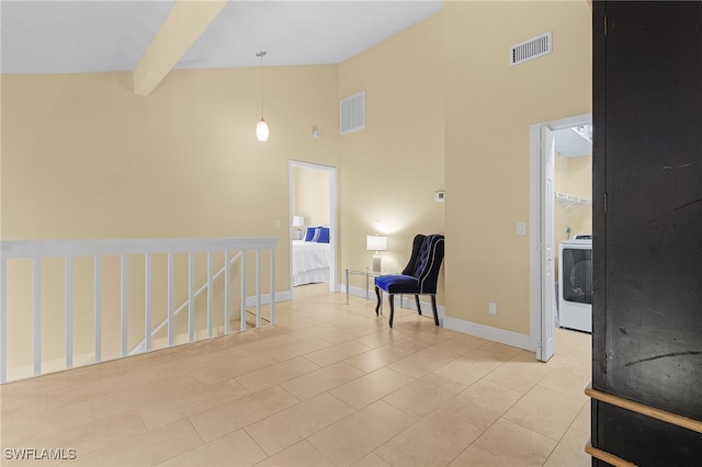 interior space featuring washer / clothes dryer, beam ceiling, light tile patterned flooring, and high vaulted ceiling