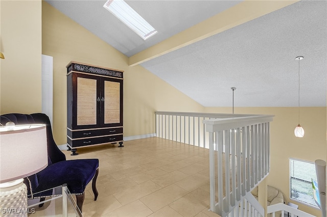 living area with beamed ceiling, light tile patterned floors, a textured ceiling, high vaulted ceiling, and a skylight