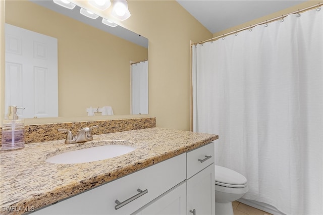 bathroom featuring vanity, toilet, and tile patterned flooring