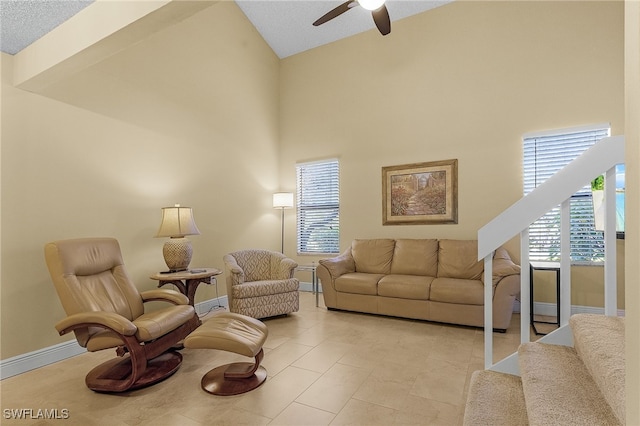 living room with high vaulted ceiling, light tile patterned floors, and ceiling fan