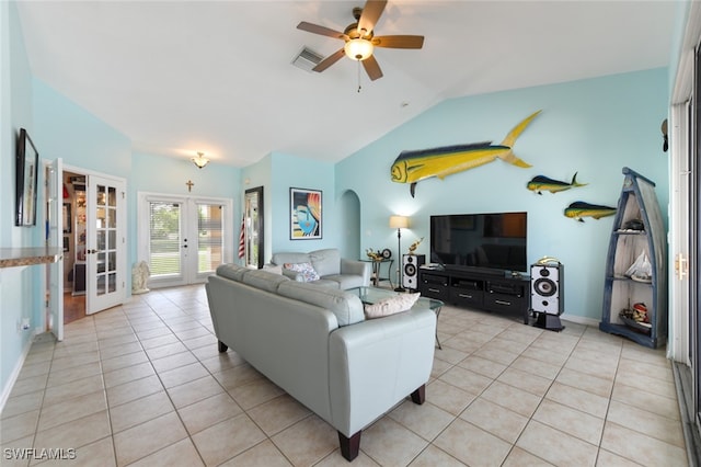 tiled living room featuring lofted ceiling, ceiling fan, and french doors