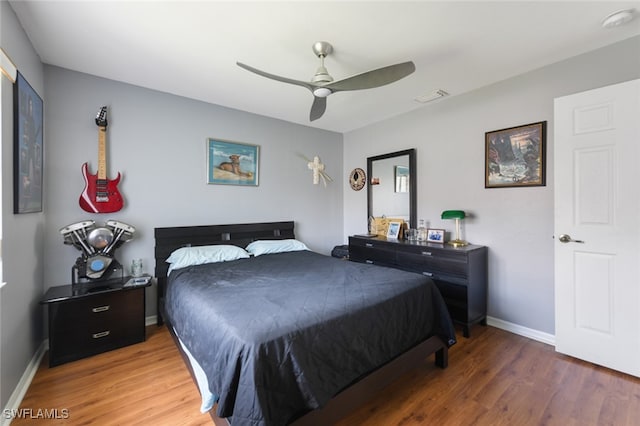 bedroom with ceiling fan and wood-type flooring