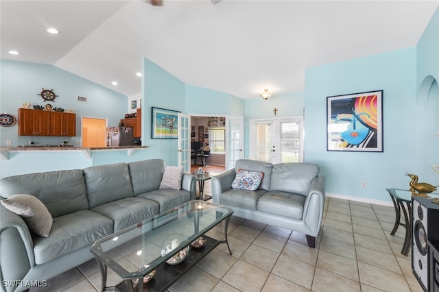 living room featuring lofted ceiling, french doors, and light tile patterned floors