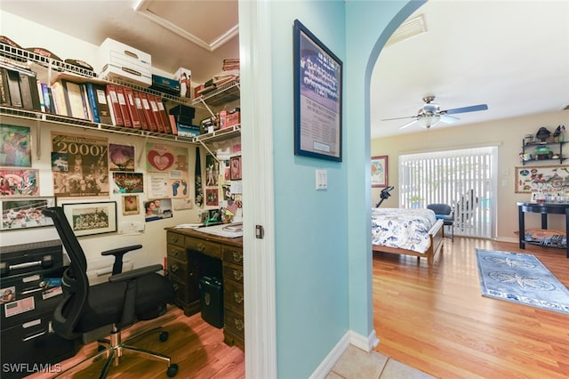 home office featuring wood-type flooring and ceiling fan