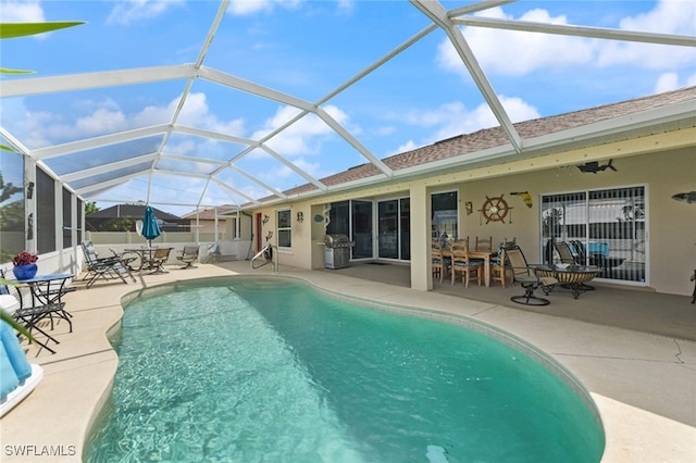 view of pool featuring ceiling fan, a lanai, area for grilling, and a patio area