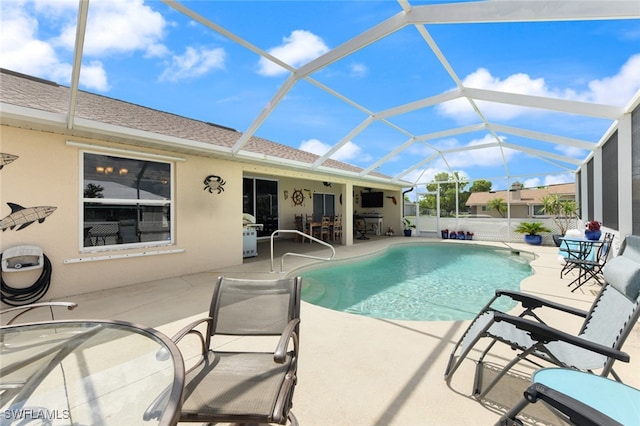 view of swimming pool featuring a lanai and a patio area