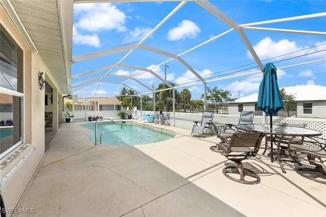 view of swimming pool with a patio and glass enclosure