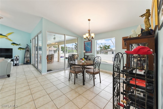 dining space with a chandelier, vaulted ceiling, and light tile patterned flooring