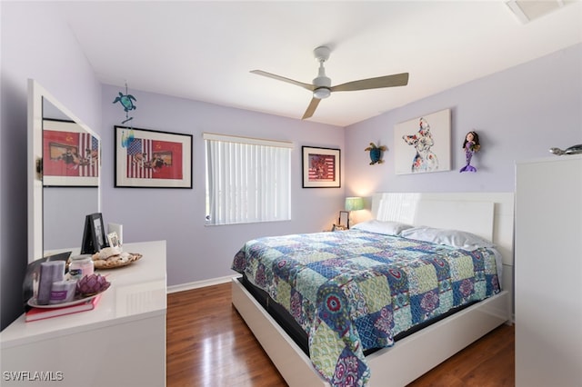 bedroom with ceiling fan and dark hardwood / wood-style flooring