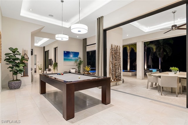 game room with a raised ceiling, ceiling fan, and billiards