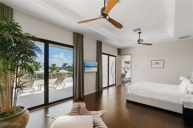 bedroom with a raised ceiling, access to exterior, ceiling fan, and dark hardwood / wood-style flooring