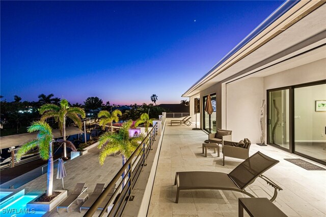 patio terrace at dusk with a balcony