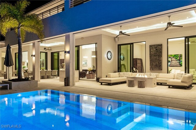 view of pool featuring an outdoor living space, a patio, and ceiling fan