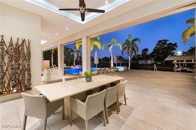 view of patio / terrace with a pool and ceiling fan