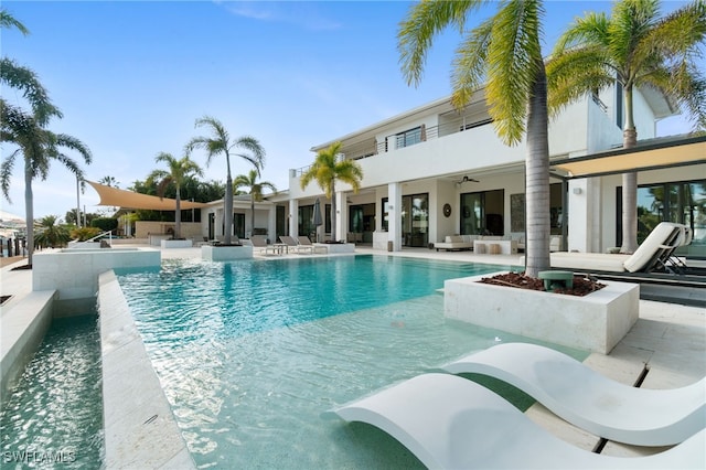 view of pool with ceiling fan and a patio area