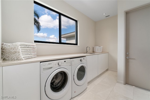 clothes washing area with cabinets, independent washer and dryer, light tile patterned floors, and sink