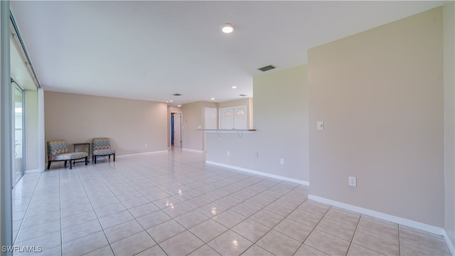 unfurnished room featuring light tile patterned flooring