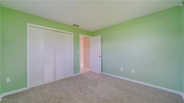 unfurnished bedroom with carpet and a closet