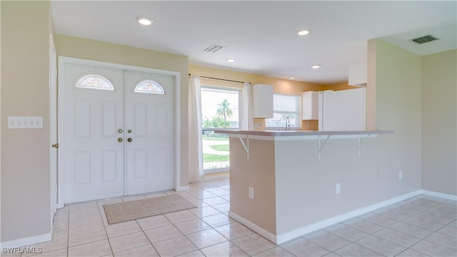 tiled entrance foyer with sink