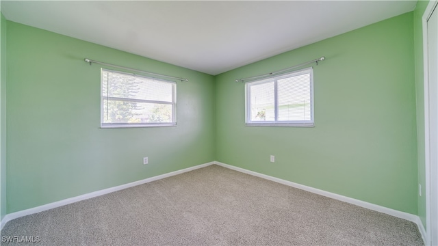 carpeted spare room featuring a healthy amount of sunlight