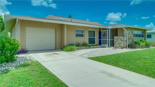 single story home with a front yard and a garage