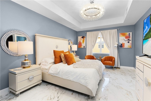 bedroom featuring a notable chandelier and a tray ceiling