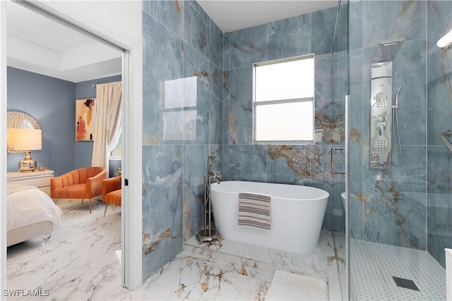 9801 Boraso Way Unit 103, Fort Myers, FL 33908 - full bathroom featuring connected bathroom, a stall shower, a freestanding tub, marble finish floors, and tile walls