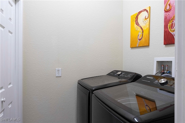 clothes washing area with washer and clothes dryer