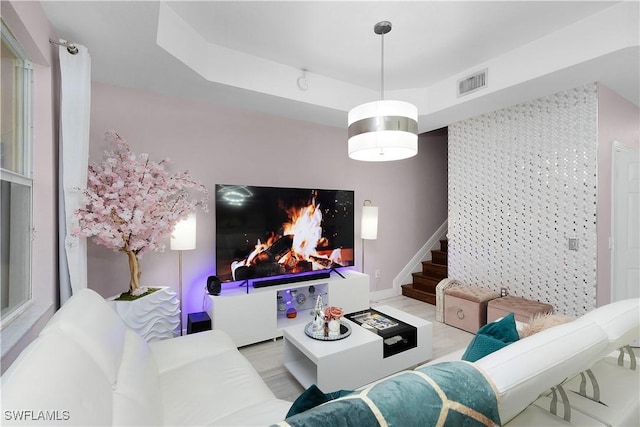 9801 Boraso Way Unit 103, Fort Myers, FL 33908 - living room featuring stairs, a tray ceiling, and wood finished floors