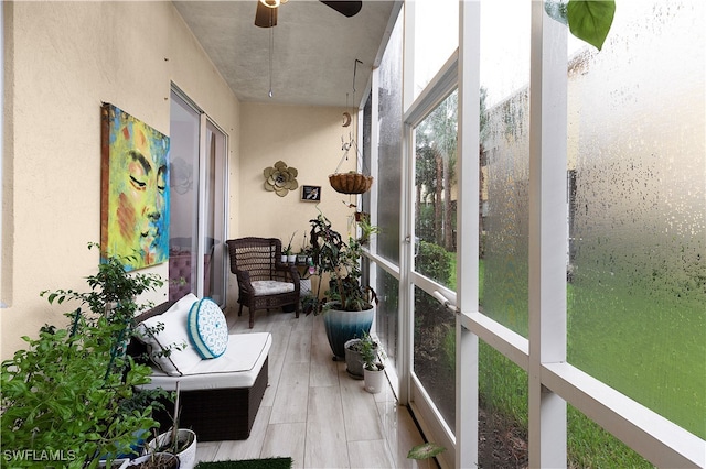 sunroom featuring ceiling fan