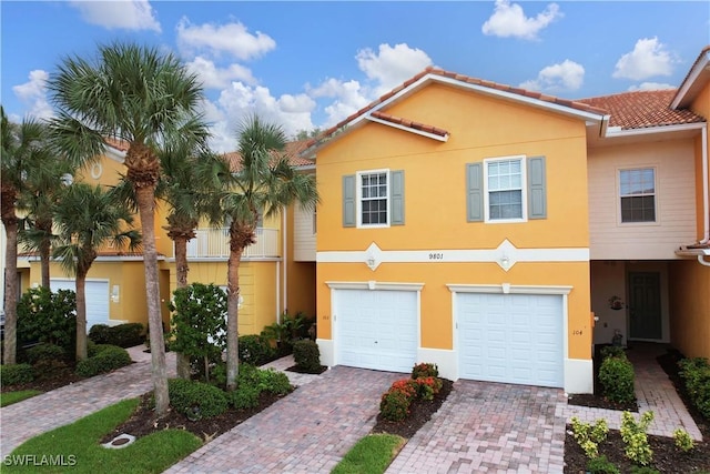 9801 Boraso Way Unit 103, Fort Myers, FL 33908 - townhome / multi-family property featuring decorative driveway, a garage, stucco siding, and a tile roof