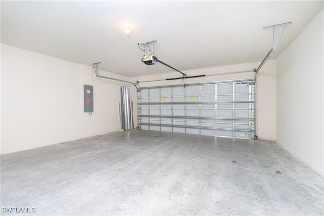 garage with a garage door opener and electric panel